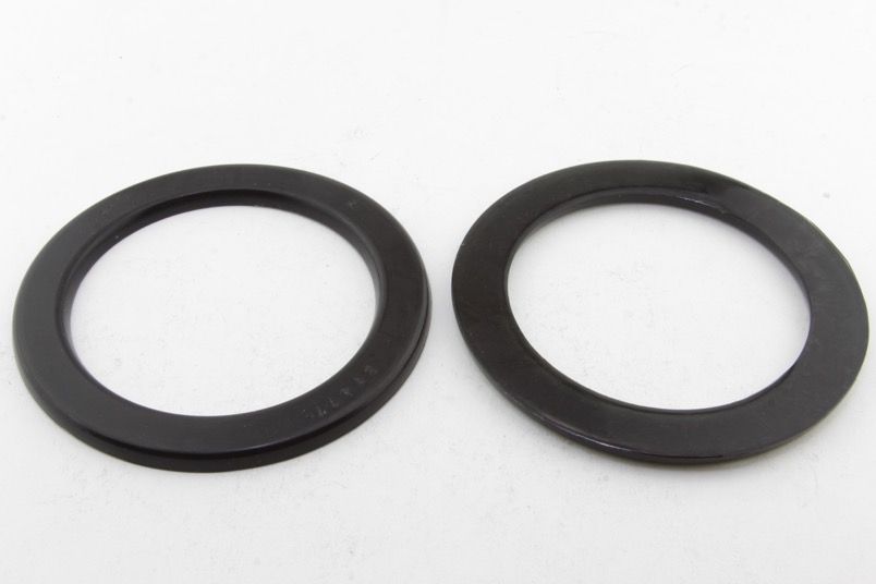 SPRING - PAD/TRIM PACKER BUSHING - REV246.0008